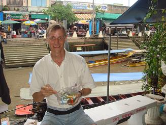 Tom eating padthai at the floating market